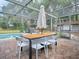 Outdoor dining area with pool view and large umbrella at 351 W 10Th Ave, Mount Dora, FL 32757