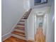 Elegant staircase with wooden steps and hardwood floors leading to upper level at 351 W 10Th Ave, Mount Dora, FL 32757