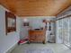 Bright sunroom features wood ceiling, antique cabinet, and window views at 351 W 10Th Ave, Mount Dora, FL 32757