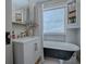 Bathroom with clawfoot tub, hexagon tile, and white vanity at 351 W 10Th Ave, Mount Dora, FL 32757