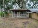 Gray cottage with a front porch and wooden deck at 351 W 10Th Ave, Mount Dora, FL 32757