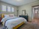 Bright bedroom with yellow bed, dresser, and patterned rug at 351 W 10Th Ave, Mount Dora, FL 32757