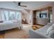 Relaxing bedroom with blush walls, hardwood floors, and a cozy sitting area at 351 W 10Th Ave, Mount Dora, FL 32757