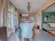 View of a dining room with a wooden table, and a view into a living room at 351 W 10Th Ave, Mount Dora, FL 32757