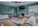 Living room with green walls, stone fireplace, and comfortable seating at 351 W 10Th Ave, Mount Dora, FL 32757