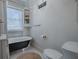Bathroom with clawfoot tub, hexagon tile floor, and shelves at 351 W 10Th Ave, Mount Dora, FL 32757