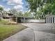 Home with a carport and a large stamped concrete driveway at 351 W 10Th Ave, Mount Dora, FL 32757
