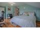 Serene bedroom with light blue walls, wood floors, and a comfortable bed at 351 W 10Th Ave, Mount Dora, FL 32757