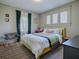 Cozy bedroom with yellow bed, patterned rug, and large window at 351 W 10Th Ave, Mount Dora, FL 32757
