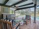 Relaxing poolside patio with seating and a glass top table at 351 W 10Th Ave, Mount Dora, FL 32757