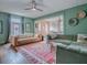 Spacious living room with green walls, hardwood floors, and comfortable seating at 351 W 10Th Ave, Mount Dora, FL 32757