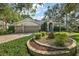 Two-story home with a three-car garage and manicured landscaping at 3646 Westover Cir, Leesburg, FL 34748
