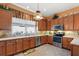Spacious kitchen with stainless steel appliances and wood cabinets at 3646 Westover Cir, Leesburg, FL 34748