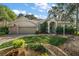 Single story home with a three car garage and manicured landscaping at 3646 Westover Cir, Leesburg, FL 34748