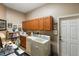 Laundry room with washer, dryer, and additional storage at 3646 Westover Cir, Leesburg, FL 34748