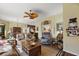 Comfortable living room featuring hardwood floors and a ceiling fan at 3646 Westover Cir, Leesburg, FL 34748
