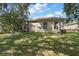 Spacious backyard with mature trees and lush grass at 3646 Westover Cir, Leesburg, FL 34748