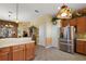 Kitchen boasts stainless steel refrigerator and ample wood cabinetry at 3646 Westover Cir, Leesburg, FL 34748