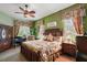 Main bedroom with a king-size bed and wood furniture at 3646 Westover Cir, Leesburg, FL 34748