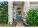 Inviting front entry with a blue door and lush landscaping at 3646 Westover Cir, Leesburg, FL 34748