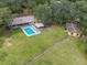 Aerial view showing house, pool, and other buildings at 36520 Micro Racetrack Rd, Fruitland Park, FL 34731