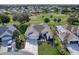 Property view showcasing the house, landscaping, and golf course at 8913 Se 132Nd Loop, Summerfield, FL 34491