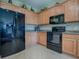 Stylish kitchen with black appliances and ample cabinet space at 8913 Se 132Nd Loop, Summerfield, FL 34491