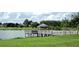 Peaceful lakeside gazebo with a wooden dock at 8913 Se 132Nd Loop, Summerfield, FL 34491