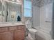 Bathroom with a shower/tub combo and wood vanity at 8913 Se 132Nd Loop, Summerfield, FL 34491