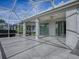 Relaxing screened patio with stamped concrete and ceiling fans at 8913 Se 132Nd Loop, Summerfield, FL 34491