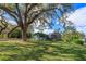 Landscaped yard with home and large trees at 10529 N Crescent Ln, Clermont, FL 34711