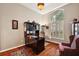 Home office with built-in desk and large window with plantation shutters at 1720 Park Forest Blvd, Mount Dora, FL 32757