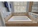Relaxing bathroom with a large soaking tub and window at 1720 Park Forest Blvd, Mount Dora, FL 32757