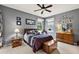 Bedroom with a queen-size bed, dresser, and ceiling fan at 1720 Park Forest Blvd, Mount Dora, FL 32757