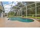 Screened-in pool with a kidney-shaped design at 1720 Park Forest Blvd, Mount Dora, FL 32757