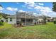 Spacious backyard with a screened pool and patio at 1720 Park Forest Blvd, Mount Dora, FL 32757