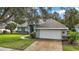 Charming one-story home with a two-car garage and manicured lawn at 1720 Park Forest Blvd, Mount Dora, FL 32757