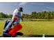 Personal golfing on a beautiful course next to a pond at 1720 Park Forest Blvd, Mount Dora, FL 32757