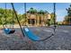 Community playground with swings and play structure at 1720 Park Forest Blvd, Mount Dora, FL 32757