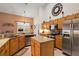 Island kitchen with granite countertops and wood cabinets at 1720 Park Forest Blvd, Mount Dora, FL 32757