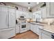 Well-equipped kitchen with white cabinets and granite countertops at 24317 Amberleaf Ct, Leesburg, FL 34748