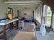 Enclosed porch with workspace and storage at 405 N Rhodes St, Mount Dora, FL 32757