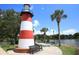 Lighthouse with benches and palm trees near water at 405 N Rhodes St, Mount Dora, FL 32757