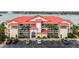 Waterfront condo building with red tile roofs and ample parking at 450 Bouchelle Dr # 301, New Smyrna Beach, FL 32169