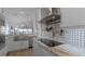 Modern kitchen with stainless steel appliances and farmhouse sink at 450 Bouchelle Dr # 301, New Smyrna Beach, FL 32169