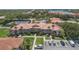 Aerial view showing building location, parking, and tennis courts at 450 Bouchelle Dr # 301, New Smyrna Beach, FL 32169