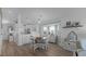 Bright eat-in kitchen with white cabinets, stainless steel appliances, and a wood dining table at 450 Bouchelle Dr # 301, New Smyrna Beach, FL 32169
