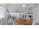 Open concept dining room with a round table, view to living room and water view at 450 Bouchelle Dr # 301, New Smyrna Beach, FL 32169