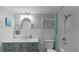 Charming bathroom with teal vanity and white subway tile at 450 Bouchelle Dr # 301, New Smyrna Beach, FL 32169