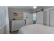 Guest bedroom with dresser and barn door to bathroom at 450 Bouchelle Dr # 301, New Smyrna Beach, FL 32169